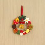 Handmade felt Christmas wreath with charming Christmas ornament design, crafted from 100% natural wool